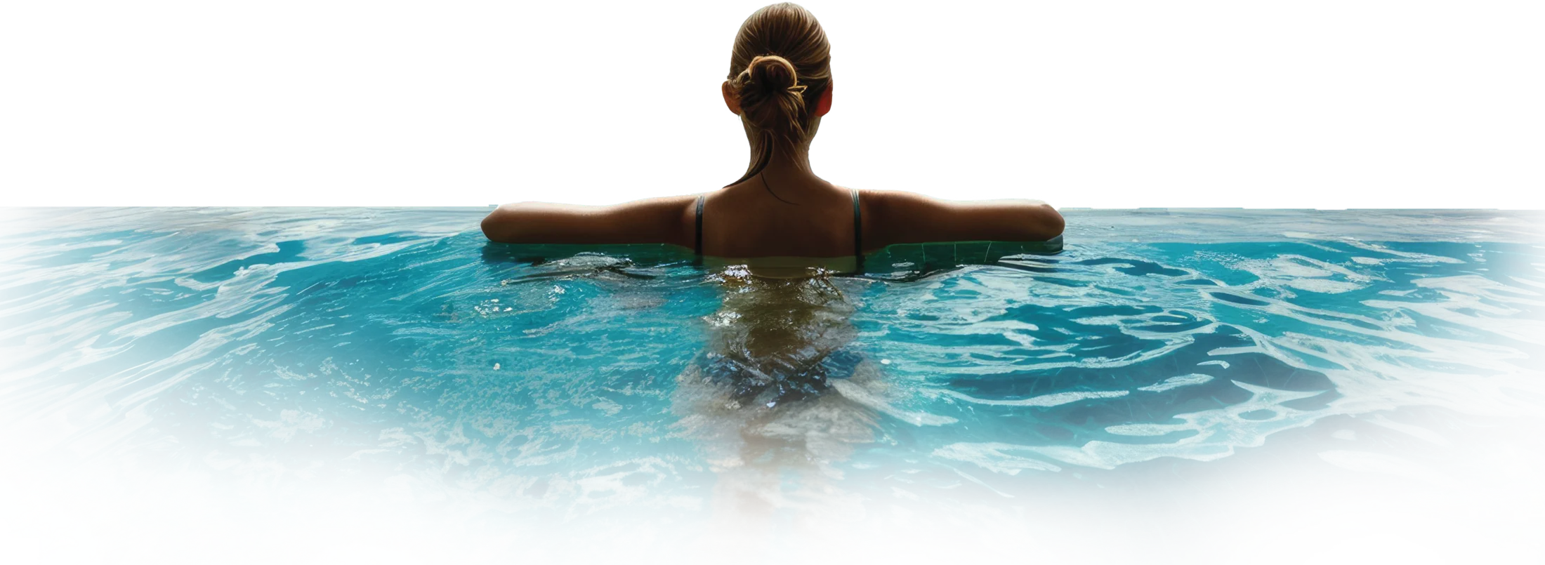 Woman resting on the edge of a turquoise infinity pool